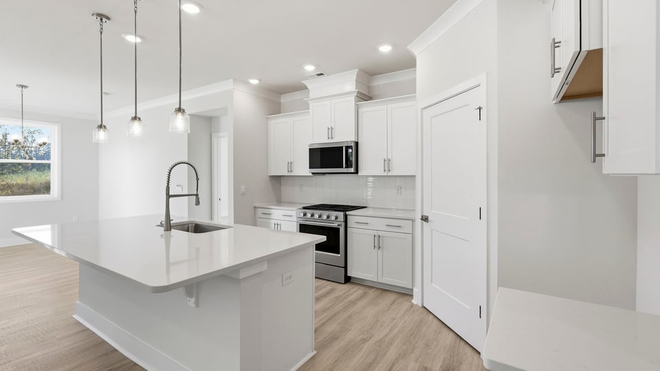 Kitchen and island with quartz countertops.