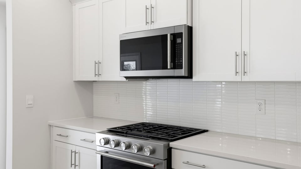 Kitchen and island with quartz countertops.