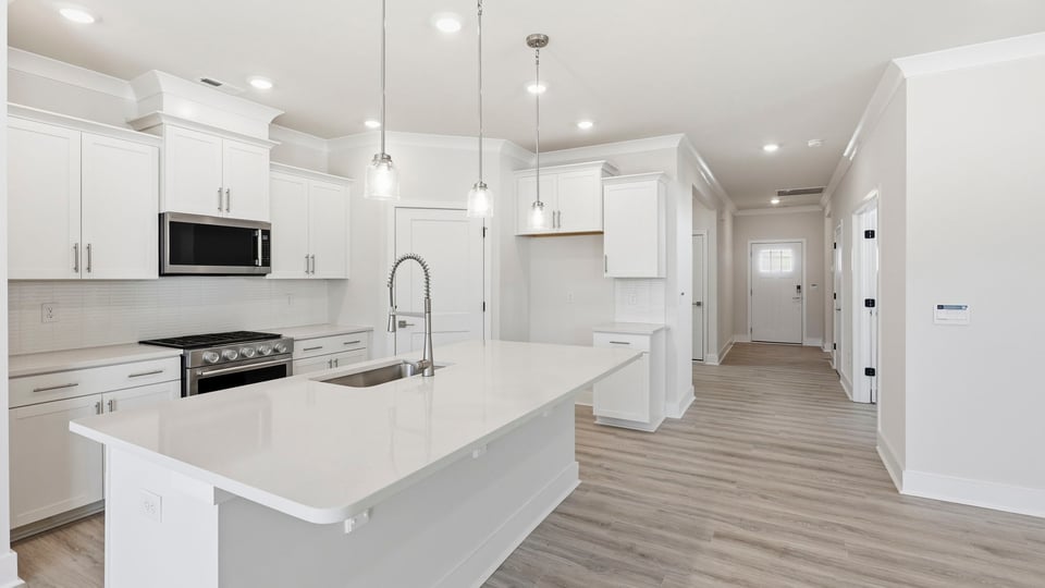 Kitchen and island with quartz countertops.