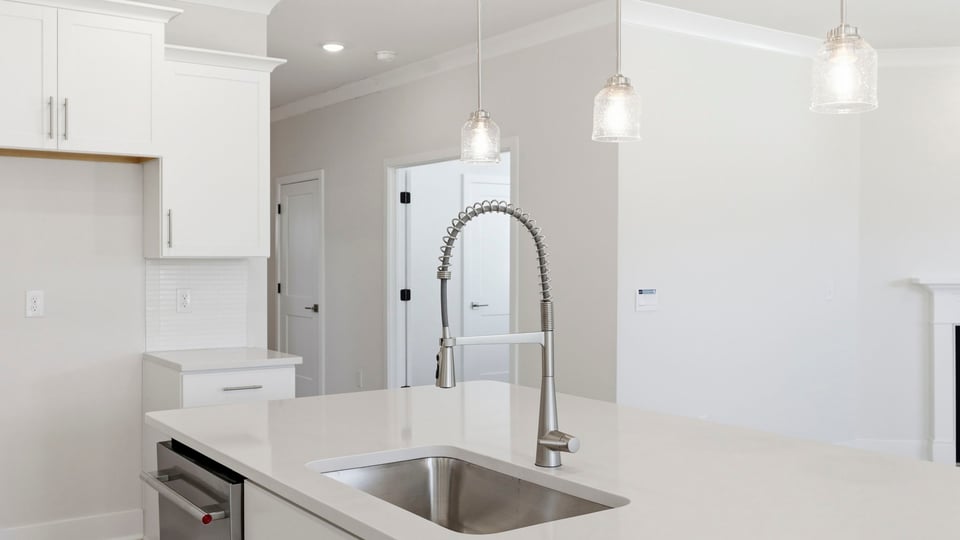 Kitchen and island with quartz countertops.