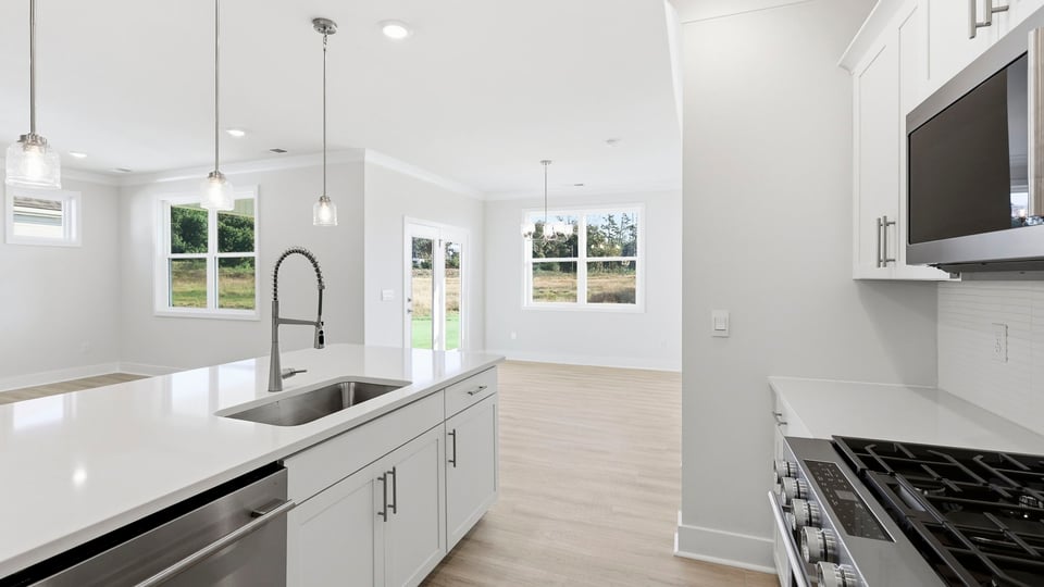 Kitchen and island with quartz countertops.