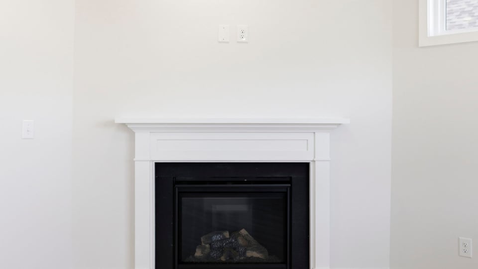 Living room with window and fireplace.