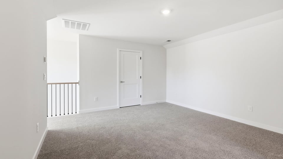 Loft area with carpet.