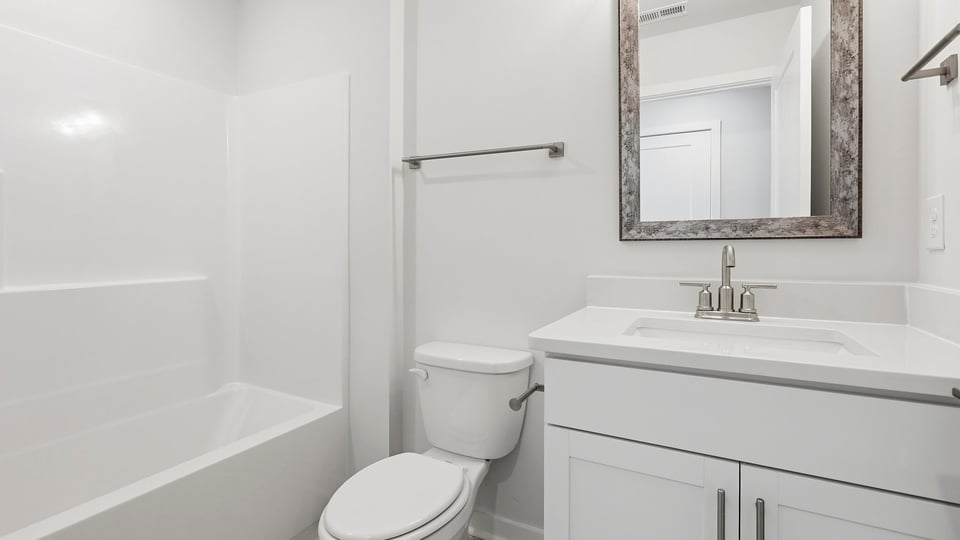 Bathroom with single vanity sink and bathtub.