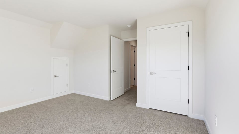 Bedroom with carpet and window.