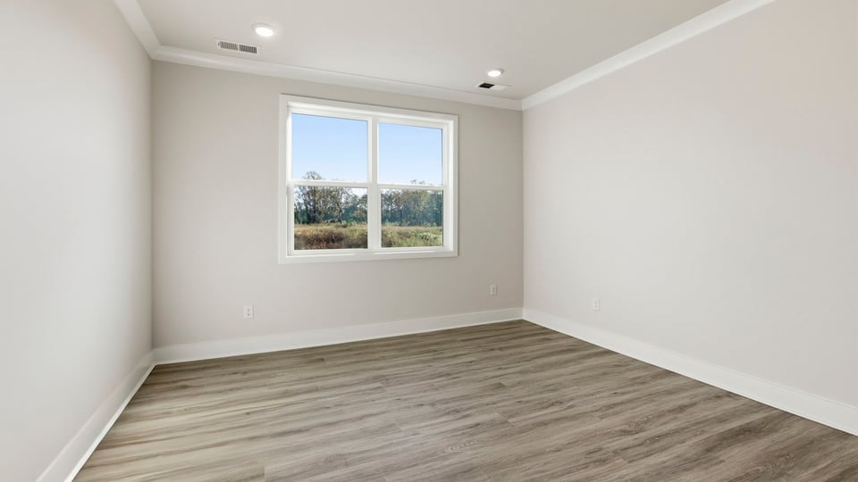 Bedroom with carpet and window.