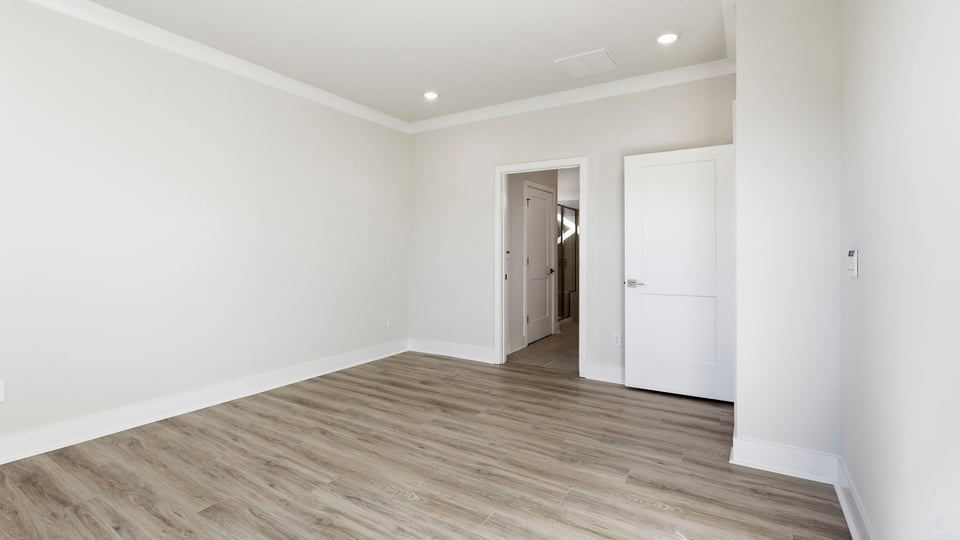 Bedroom with carpet and window.