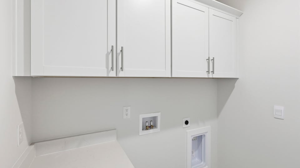 Laundry room with cabinets.