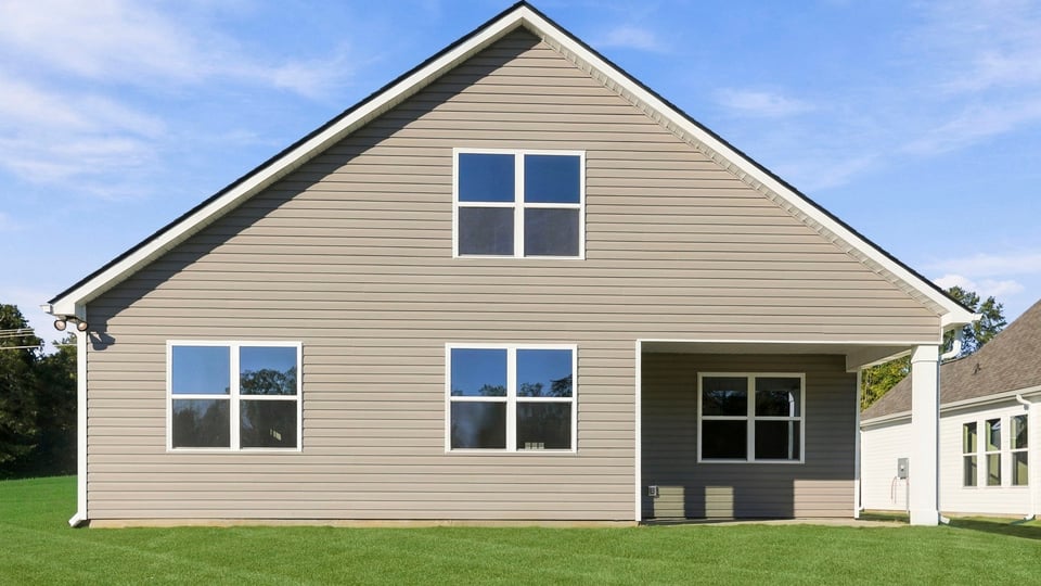 Back exterior of home with large backyard.