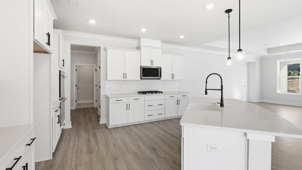 Kitchen and island with quartz countertops.