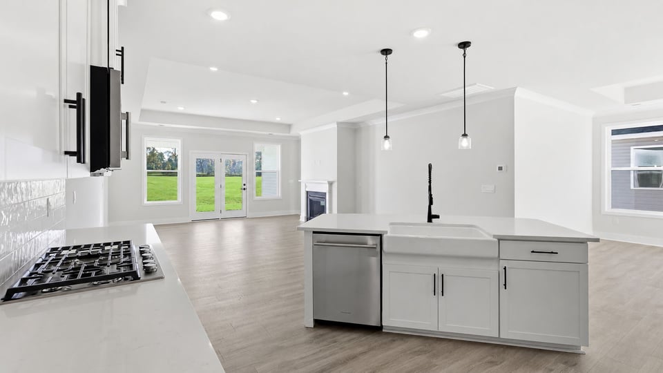 Kitchen and island with quartz countertops.