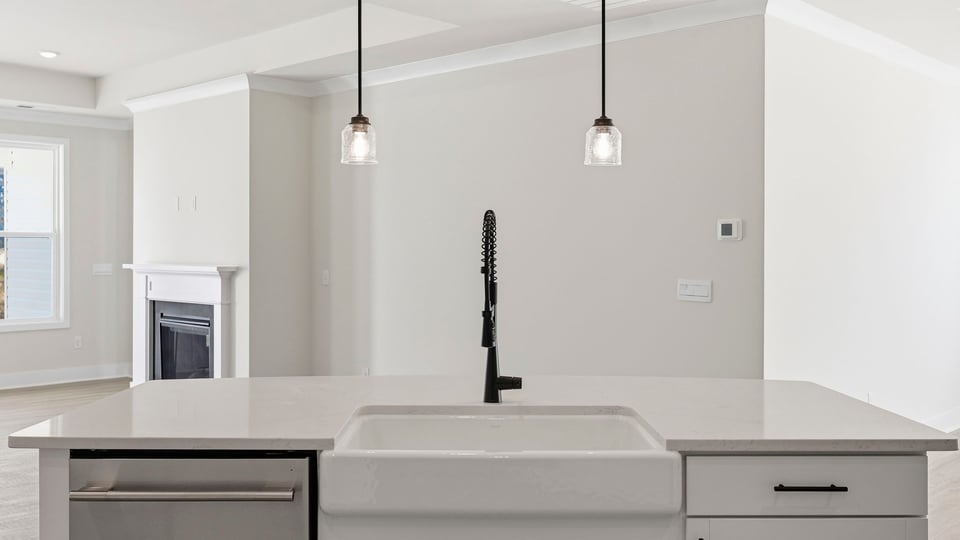 Kitchen and island with quartz countertops.