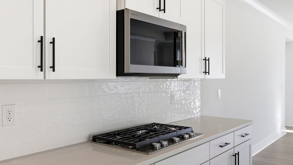 Kitchen and island with quartz countertops.