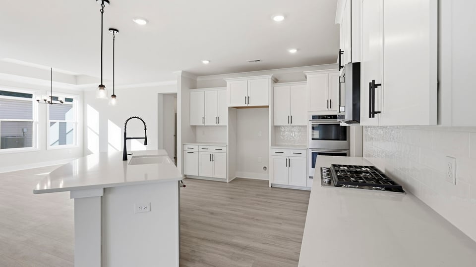 Kitchen and island with quartz countertops.