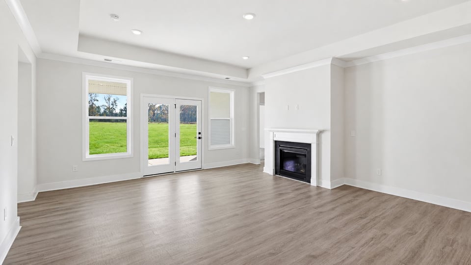 Living room with fireplace and windows.