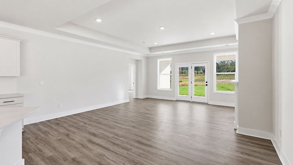 Living room with fireplace and windows.