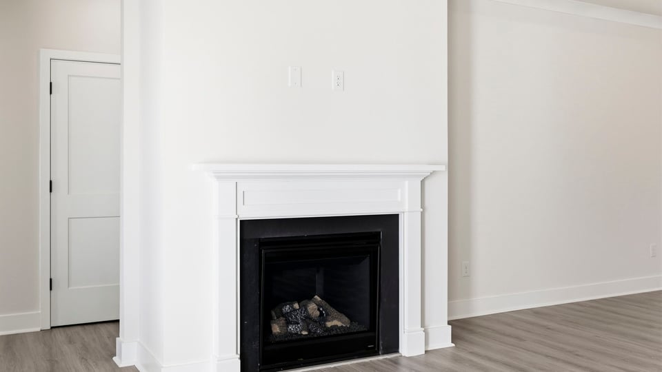 Living room with fireplace and windows.