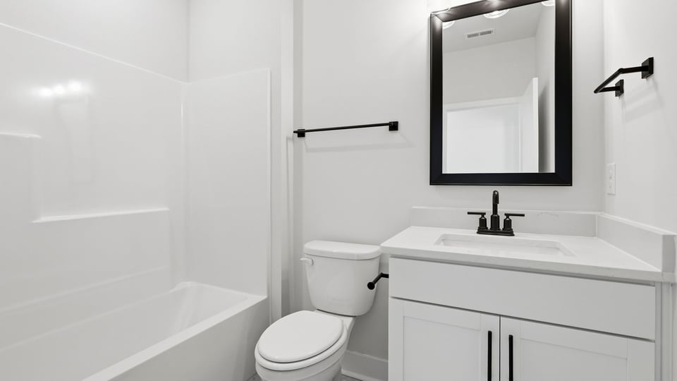 Bathroom with single vanity sink and bathtub.