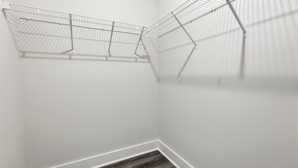 Closet with hanging storage racks.