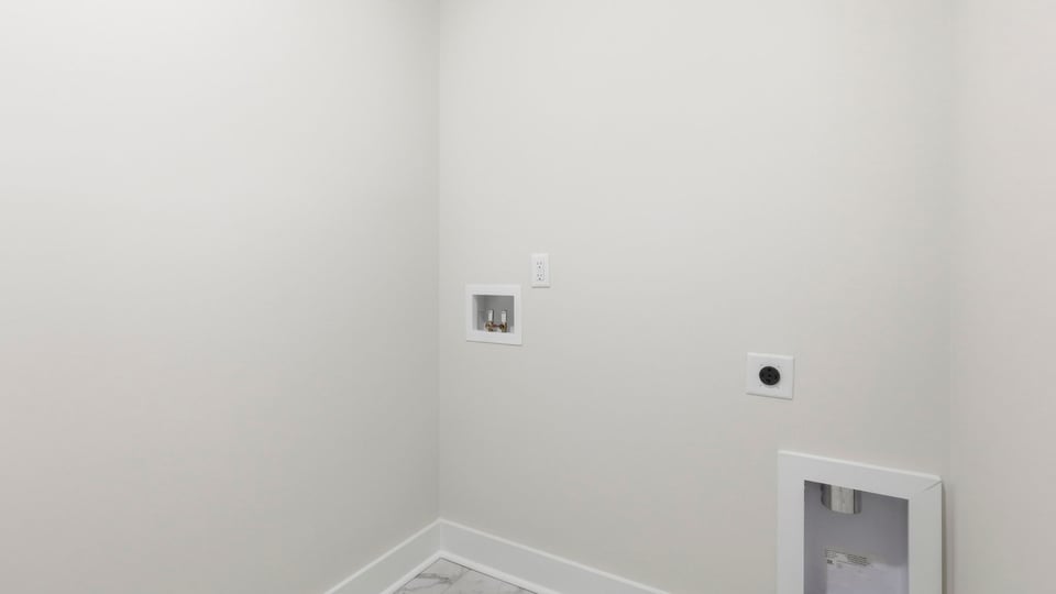 Laundry room with hanging storage racks.