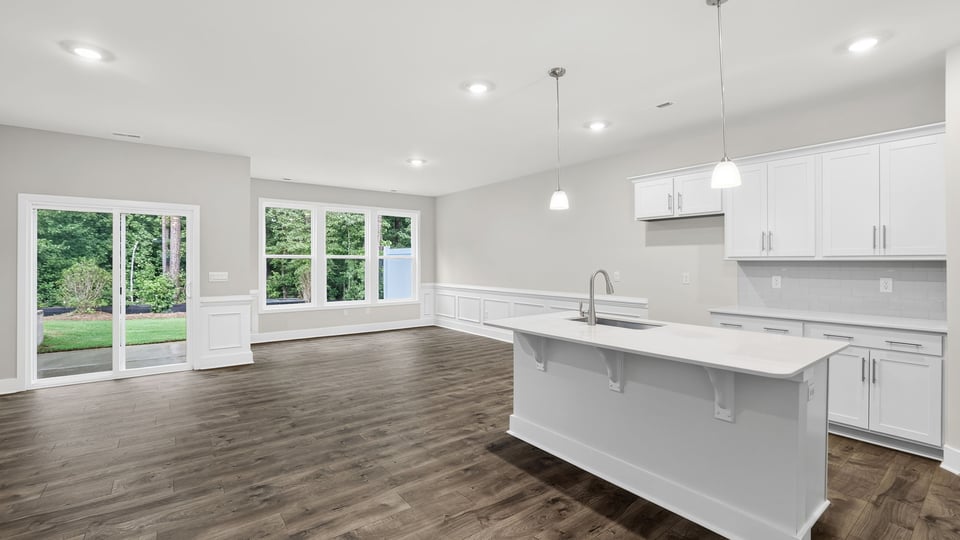 Kitchen and island with quartz countertops.