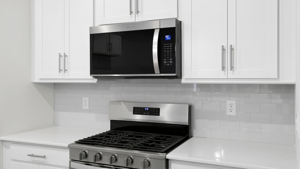 Kitchen and island with stainless steel appliances.