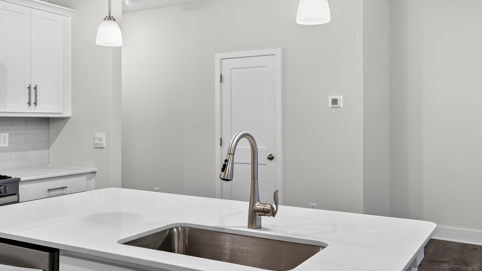 Kitchen and island with stainless steel appliances.