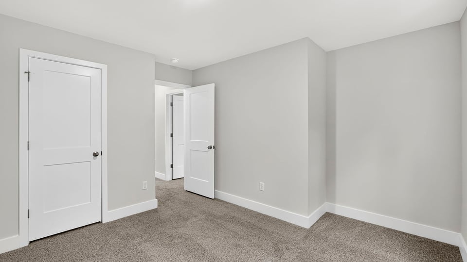 Bedroom with carpet and window.