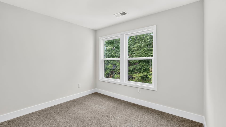 Bedroom with carpet and window.