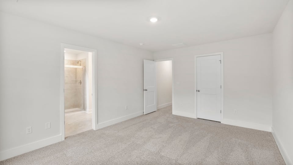 Bedroom with carpet and window.