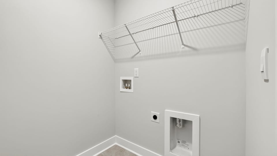 Laundry room with hanging storage racks.