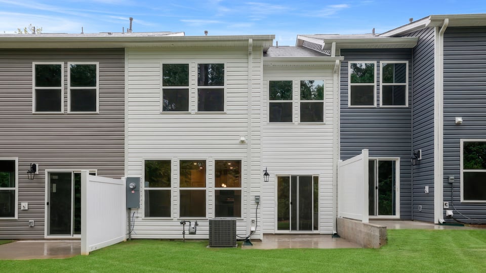 Back exterior of home with large backyard.