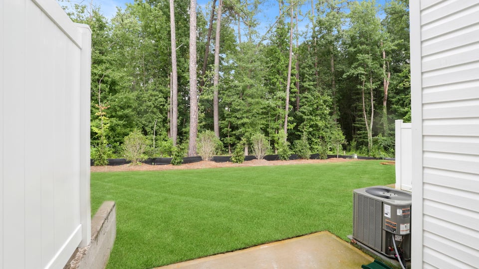 Back exterior of home with patio.