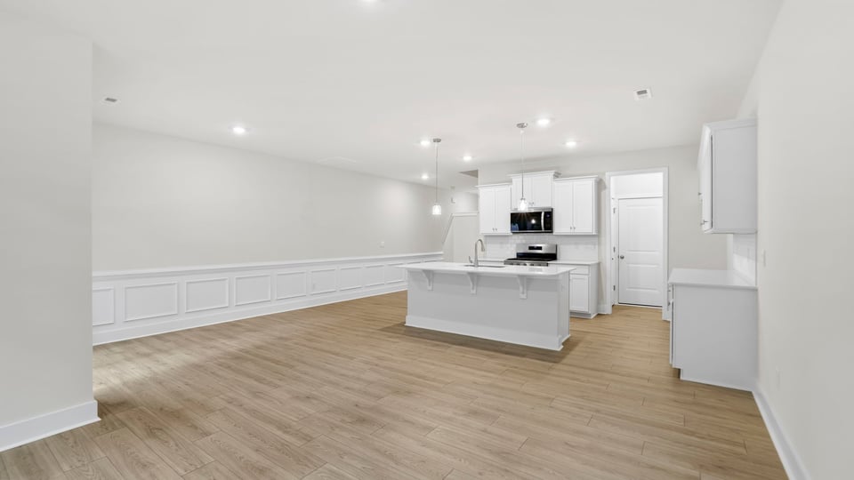 Kitchen and island with quartz countertops.