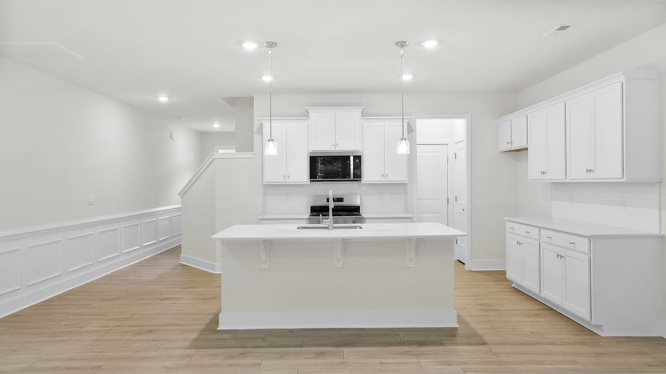 Kitchen and island with quartz countertops.