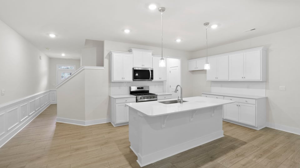 Kitchen and island with quartz countertops.