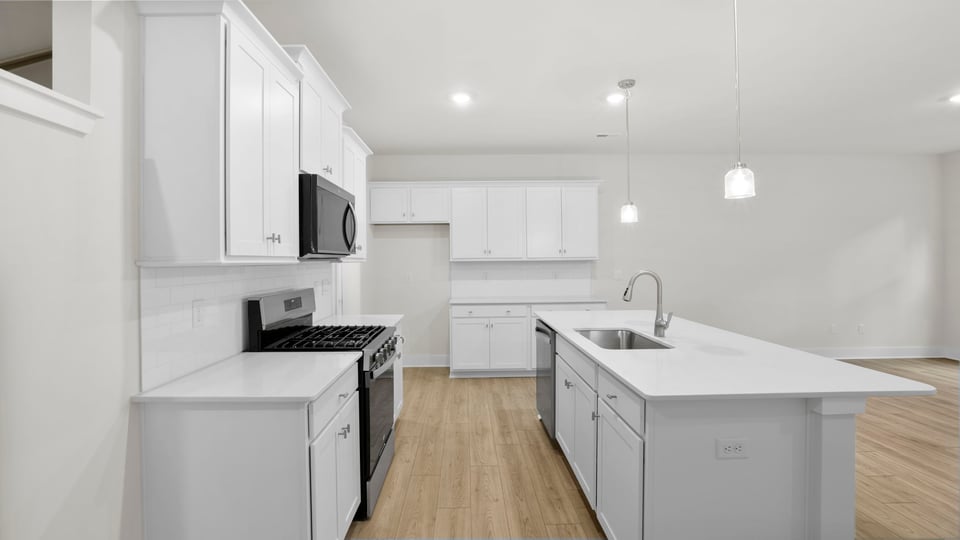 Kitchen and island with quartz countertops.
