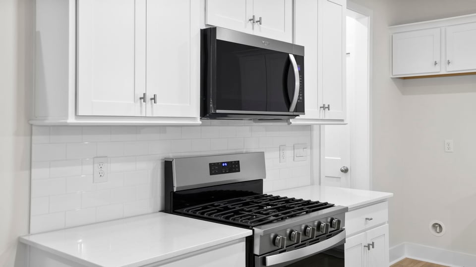 Kitchen and island with quartz countertops.