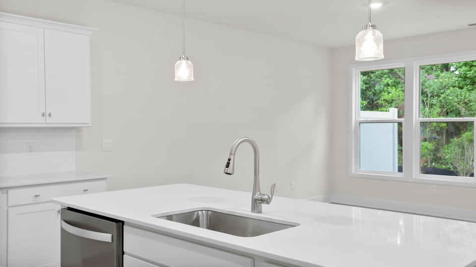 Kitchen and island with quartz countertops.