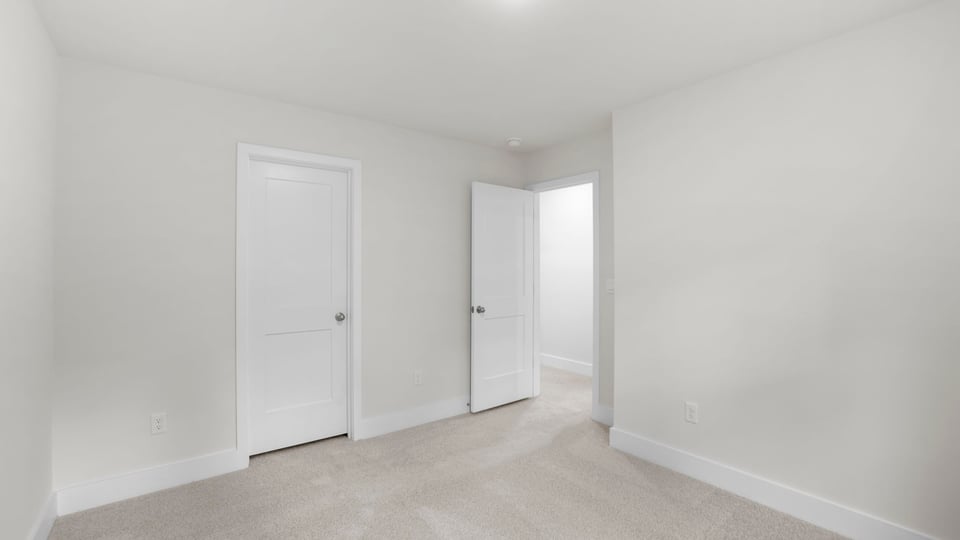 Bedroom with carpet and window.