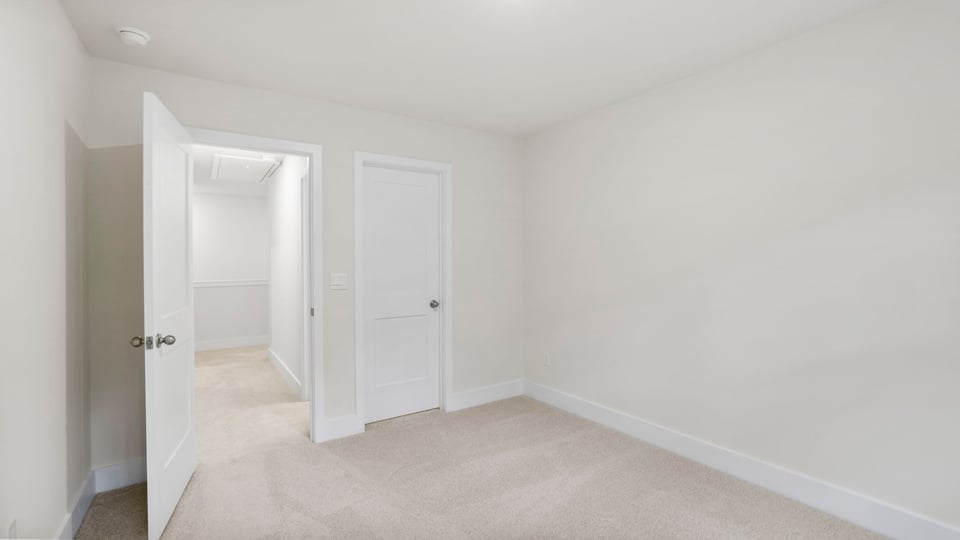 Bedroom with carpet and window.