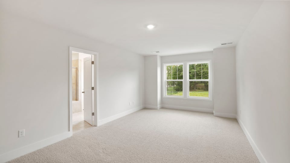 Bedroom with carpet and window.