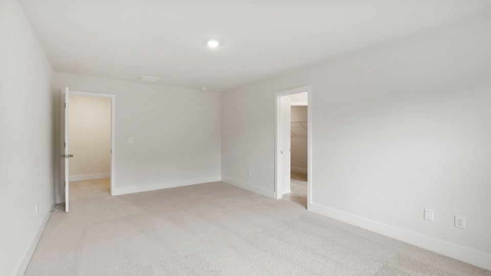 Bedroom with carpet and window.