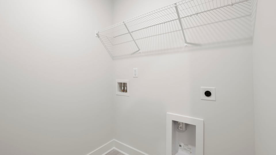 Laundry room with hanging storage racks.