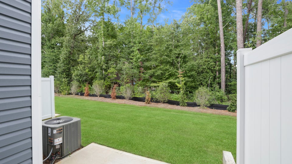 Back exterior of home with yard.