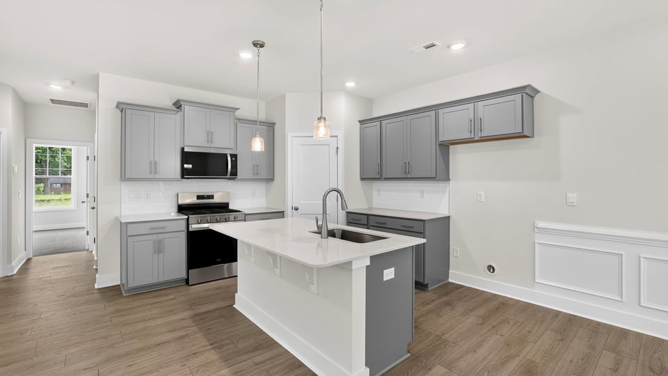 Kitchen and island with quartz countertops.