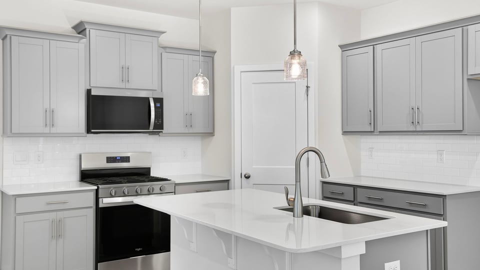 Kitchen and island with quartz countertops.