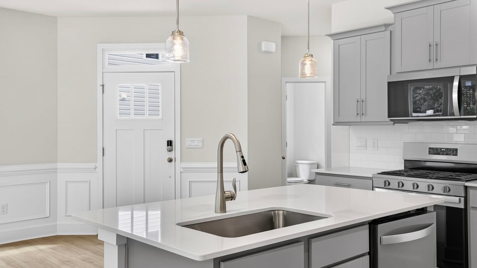 Kitchen and island with quartz countertops.