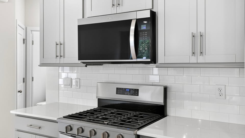 Kitchen and island with quartz countertops.