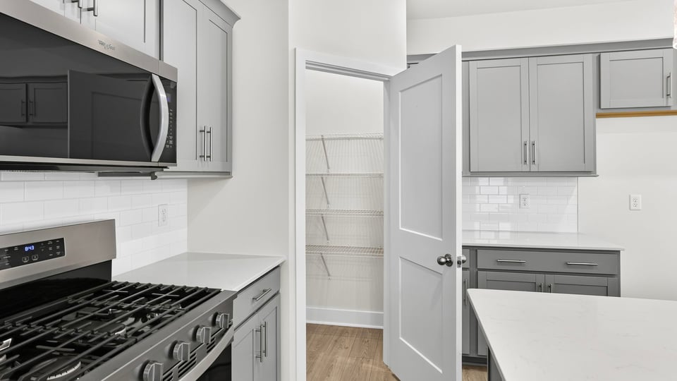 Kitchen and island with quartz countertops.